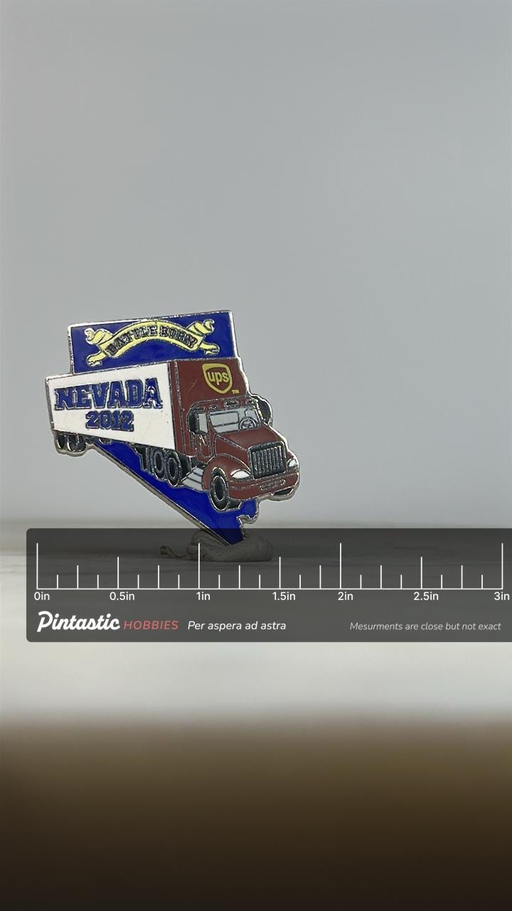 Nevada UPS Truck Pin: Red & Blue Enamel - 2012 State Souvenir Accessory with ruler overlay for size reference