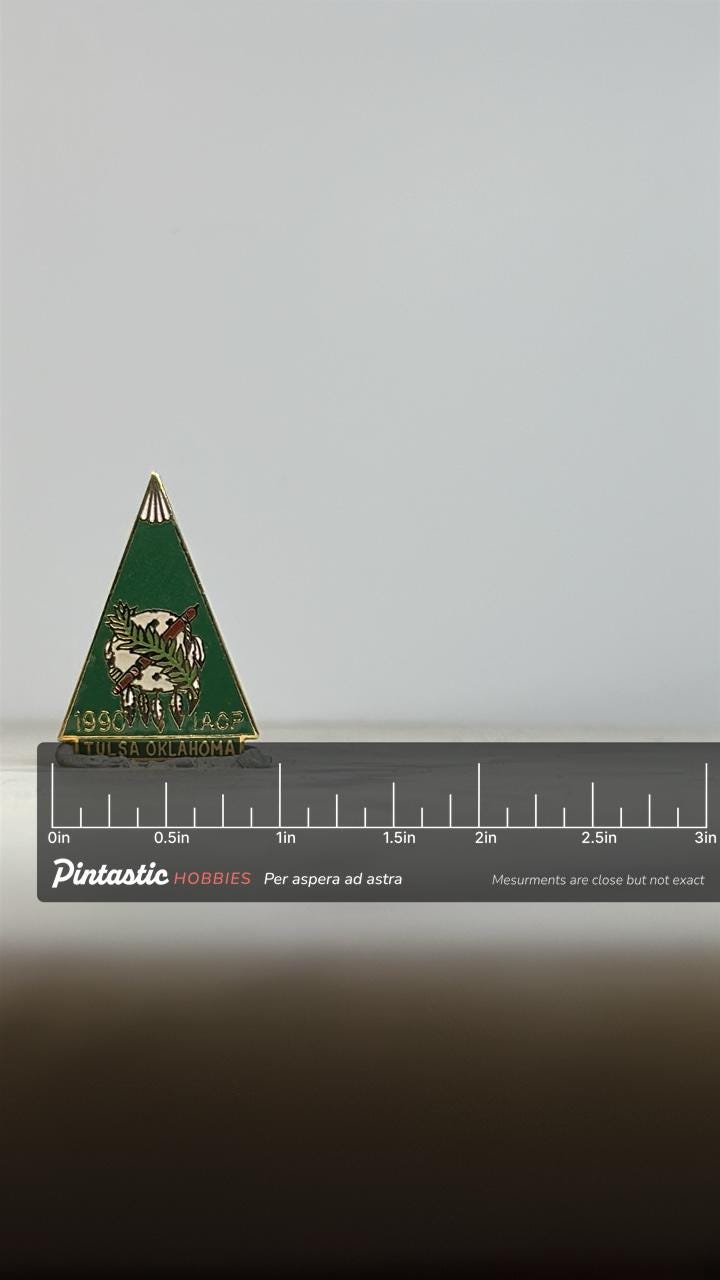 IACP Tulsa Oklahoma Pin: Green Triangle Enamel - 1990 Collectible Accessory with ruler overlay for size reference