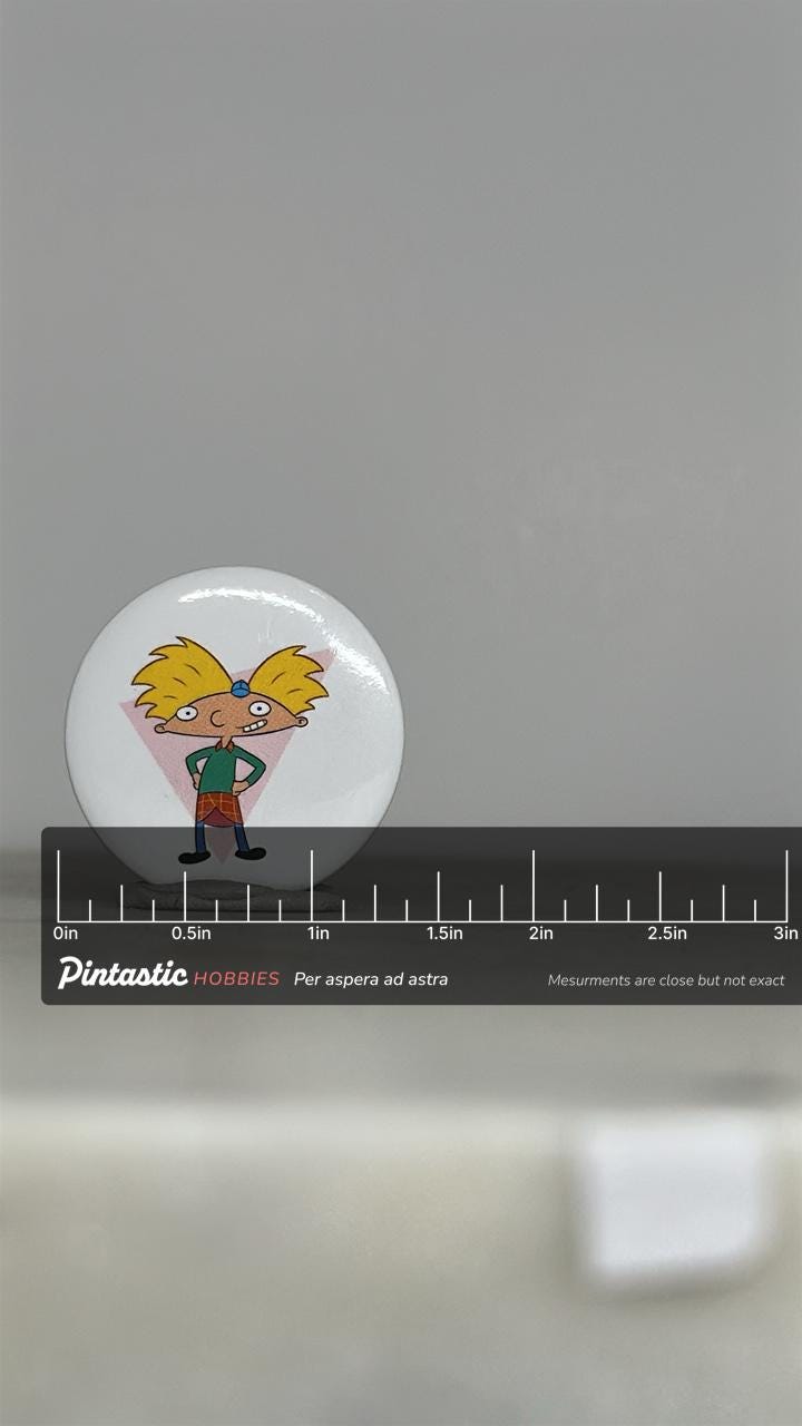 Vintage Hey Arnold Button Pin: Glossy Cartoon Style - 90s Nickelodeon Accessory with ruler overlay for size reference