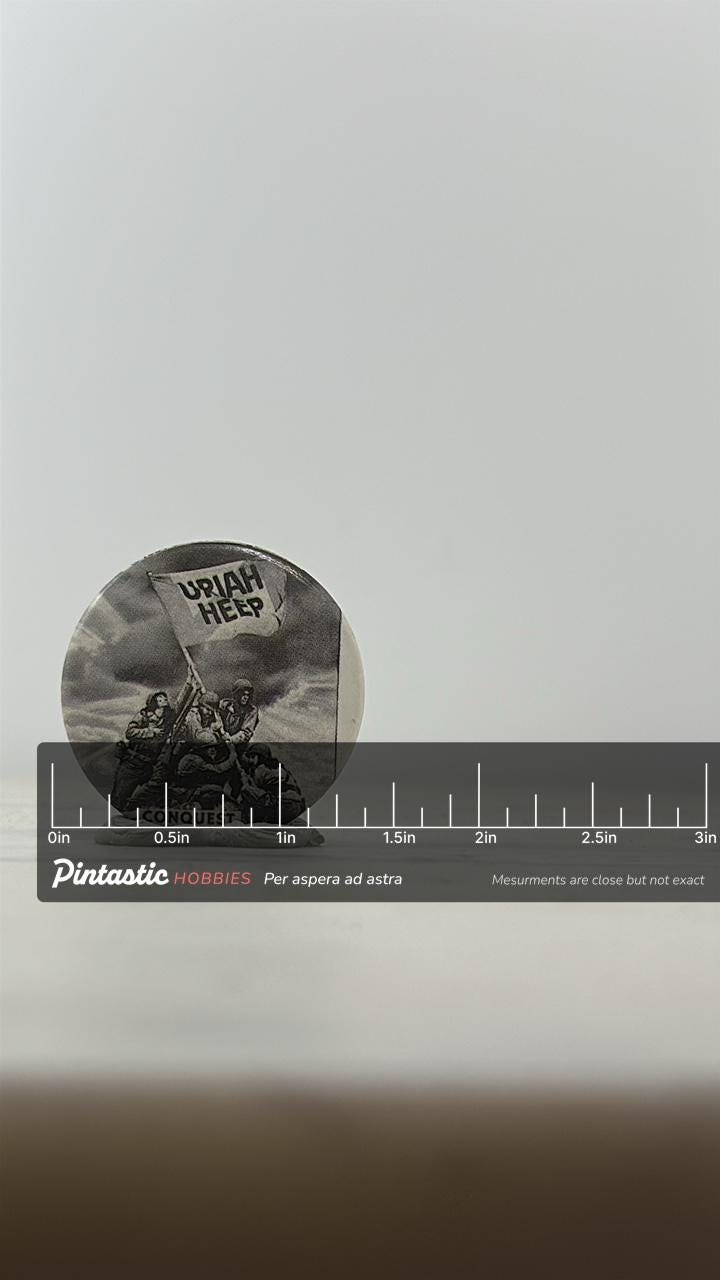 Uriah Heep Band Pin: Black & White Round - Vintage Rock Accessory with ruler overlay for size reference