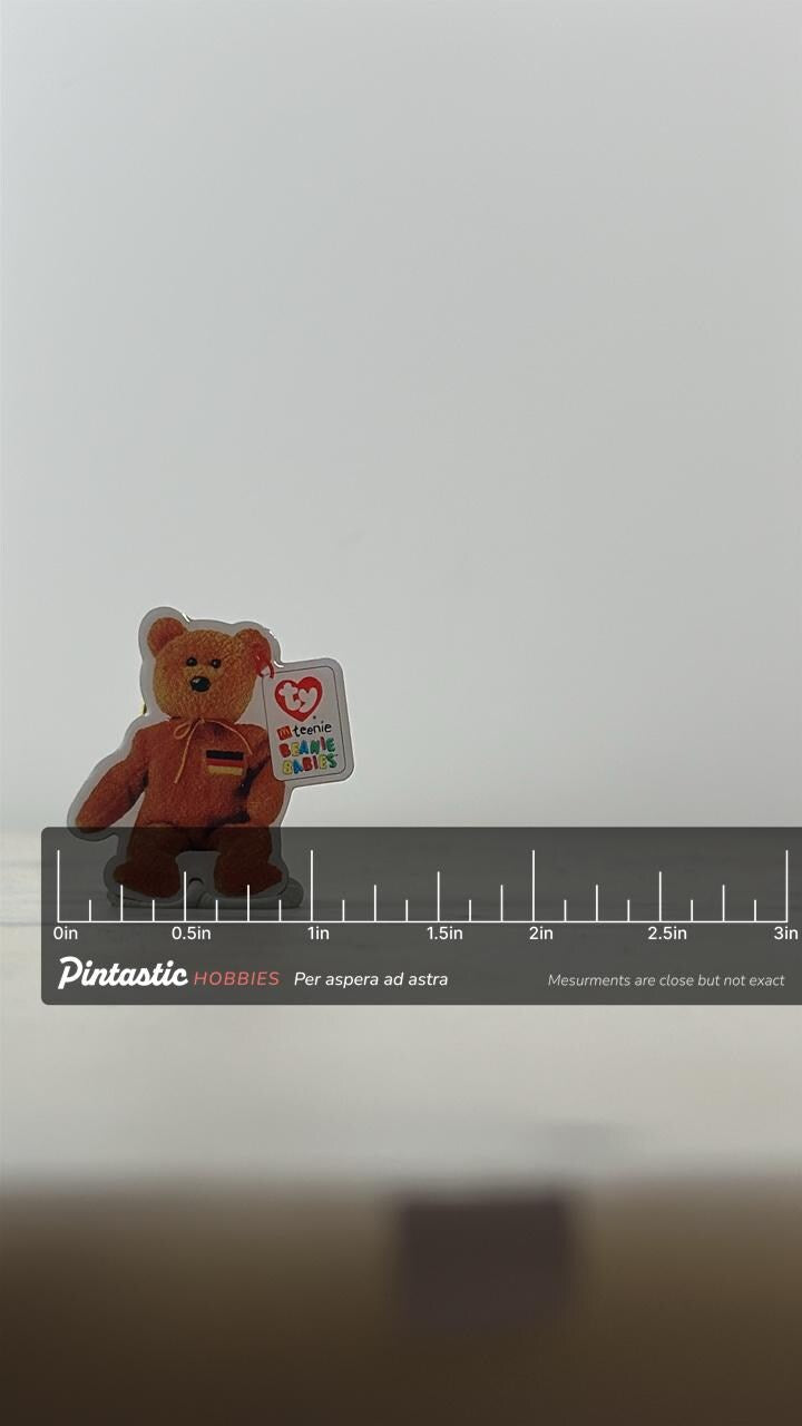 Ty Beanie Baby Enamel Pin: Brown Bear with Tag - 90s Collectible Accessory with ruler overlay for size reference