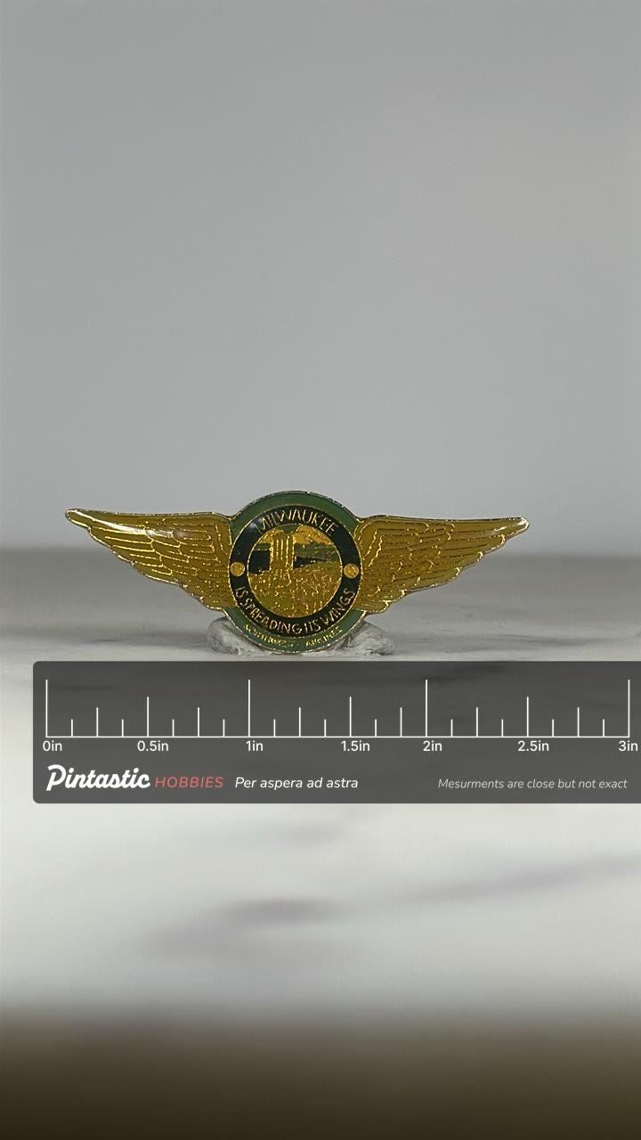 Milwaukee Wings Enamel Pin: Gold & Green - Vintage Travel Accessory with ruler overlay for size reference