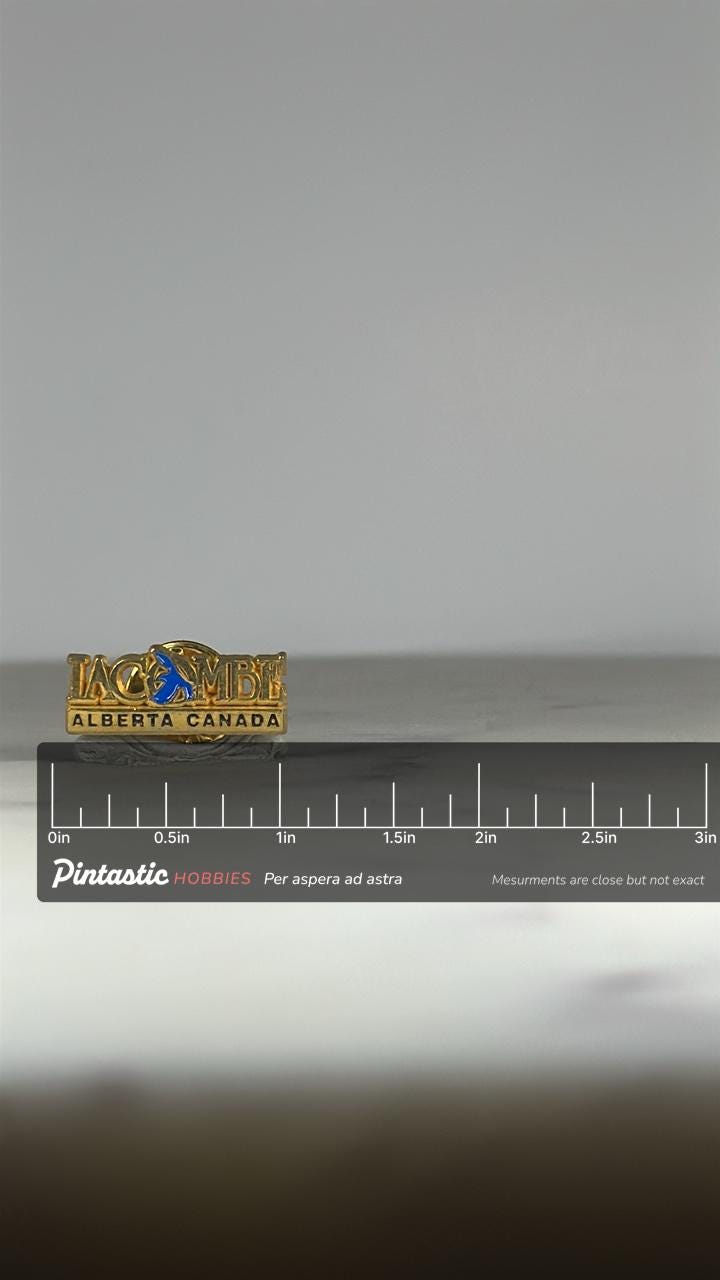 Lacombe Alberta Canada Souvenir Pin: Gold & Blue Enamel - Vintage Travel Accessory with ruler overlay for size reference