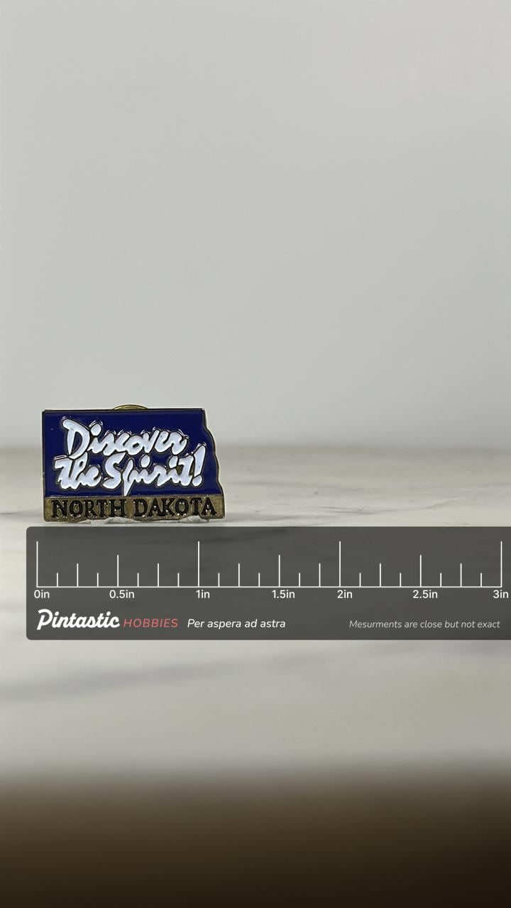 North Dakota State Pin: Blue Enamel Brass Finish - Vintage Travel Accessory with ruler overlay for size reference