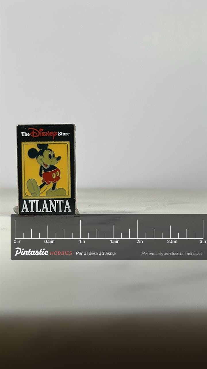 Atlanta Disney Store Pin: Mickey Mouse Black Enamel - Vintage Collectible Accessory with ruler overlay for size reference