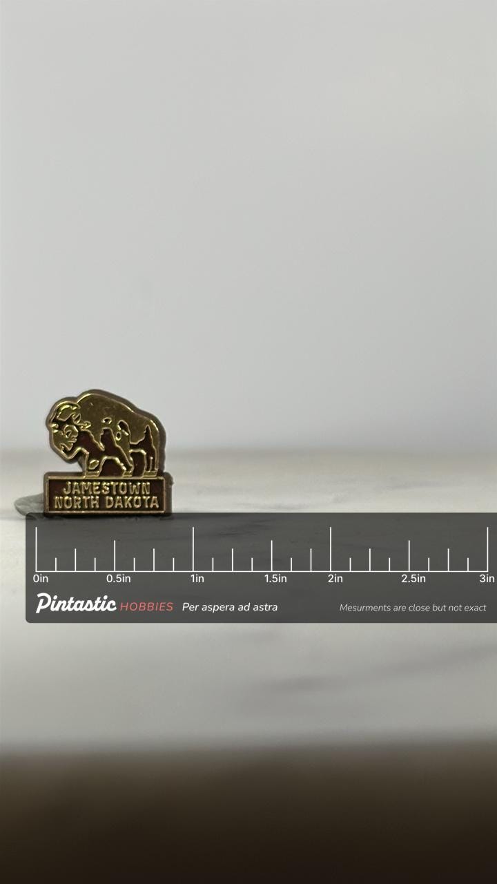 Jamestown North Dakota Souvenir Pin: Gold & Brown Enamel - Vintage Travel Accessory with ruler overlay for size reference