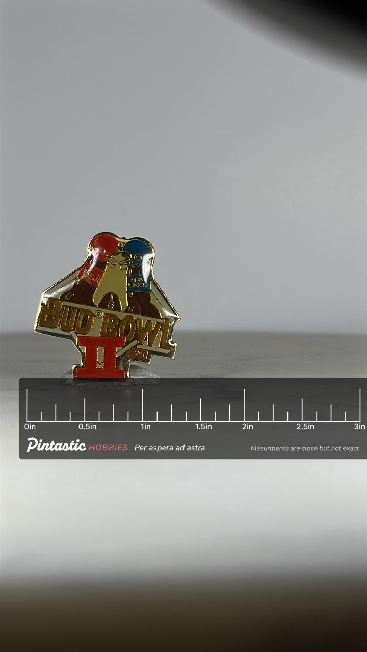 Bud Bowl II Enamel Pin: Red & Blue Helmet Design - 1990s Beer Promo Accessory with ruler overlay for size reference