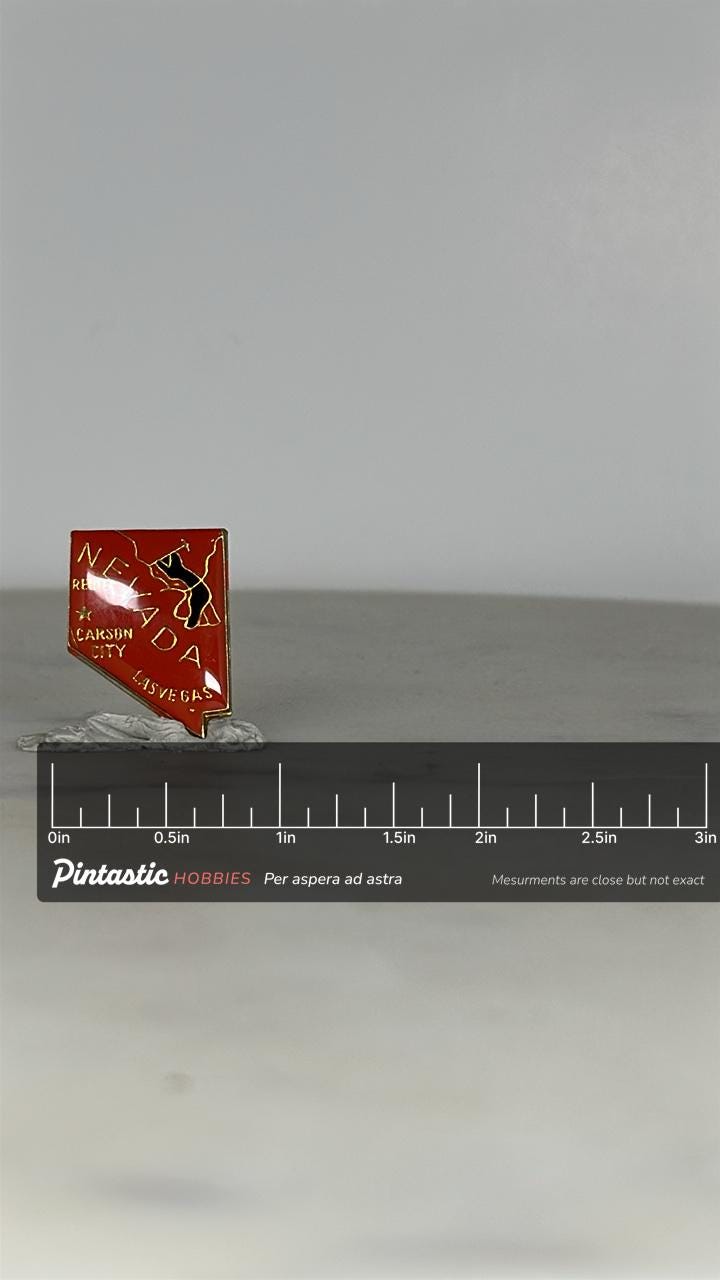 Nevada State Souvenir Pin: Red Enamel Gold Trim - Vintage Travel Accessory with ruler overlay for size reference