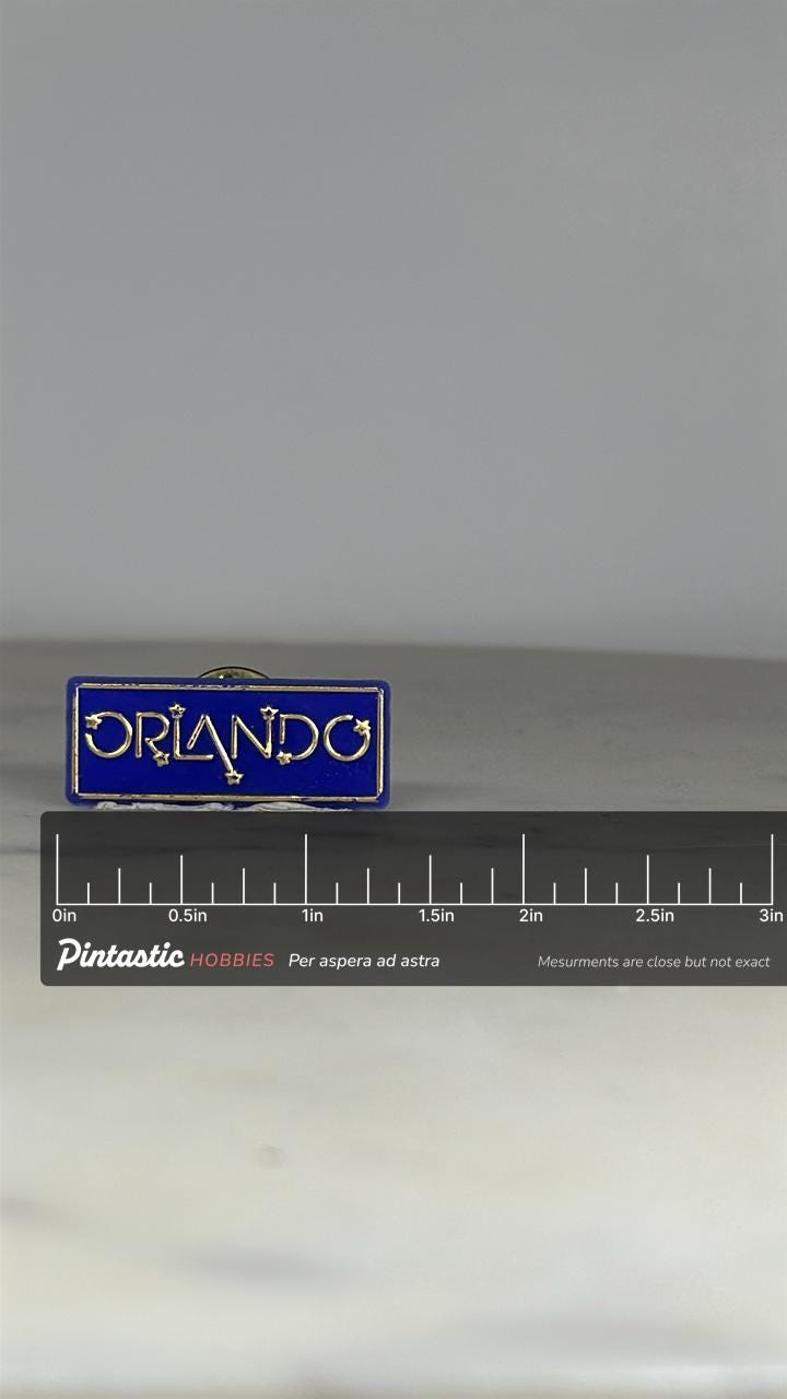 Orlando Souvenir Pin: Blue Enamel Gold Trim - Vintage Travel Accessory with ruler overlay for size reference