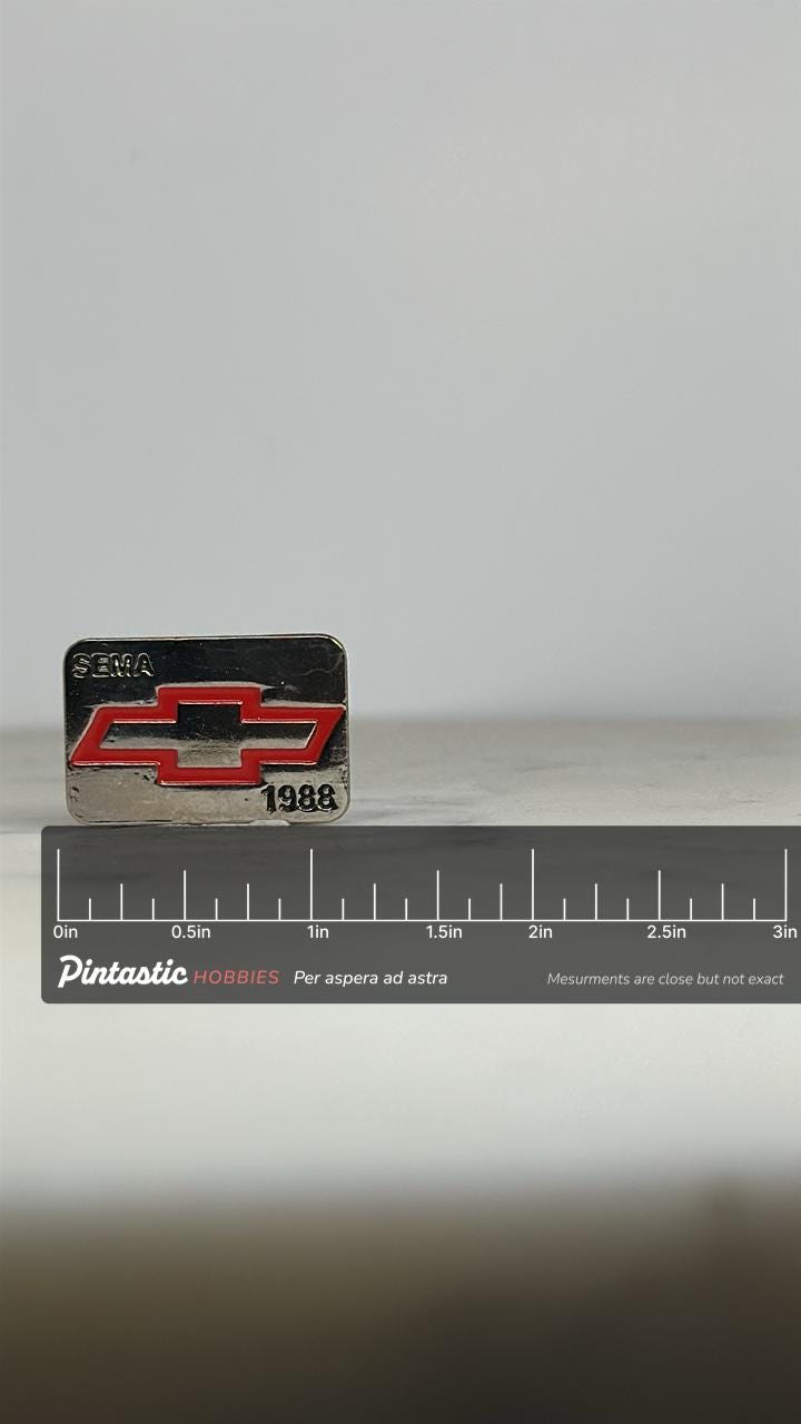 Chevy SEMA Enamel Pin: Red Logo on Silver - 1988 Auto Show Accessory with ruler overlay for size reference