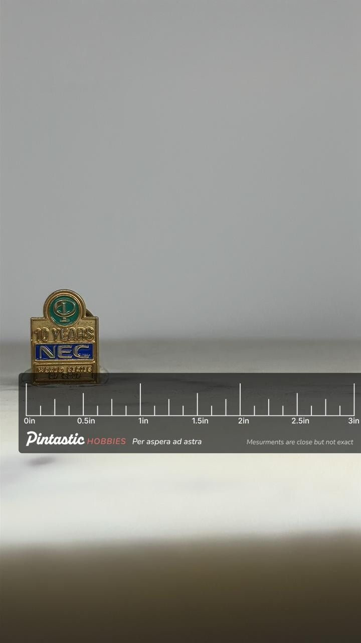 NEC Golf Enamel Pin: Gold Blue Green Finish - 10 Year Commemorative Accessory with ruler overlay for size reference