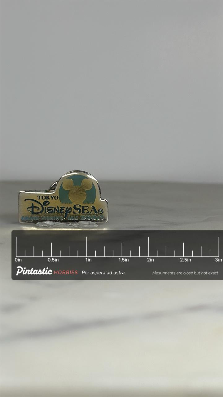 Tokyo DisneySea Pin: Gold & Teal Enamel - 2001 Grand Opening Accessory with ruler overlay for size reference