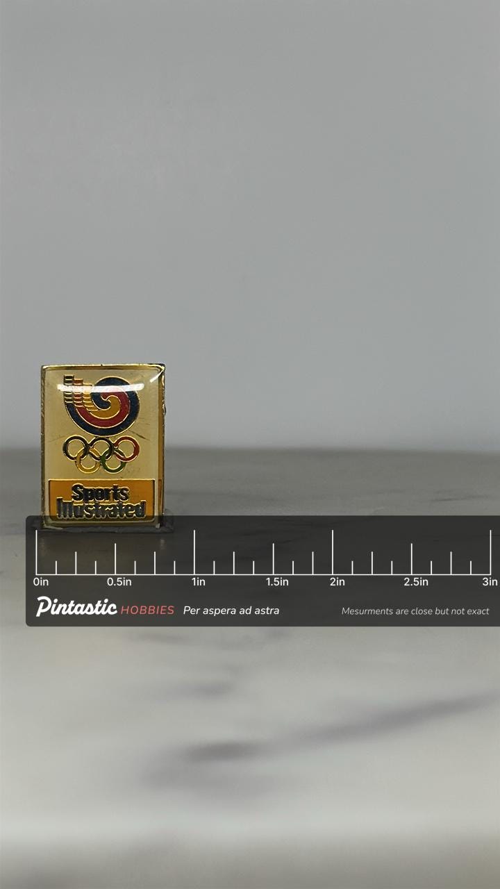 Sports Illustrated Olympic Pin: Gold Enamel Finish - 1980s Media Accessory with ruler overlay for size reference