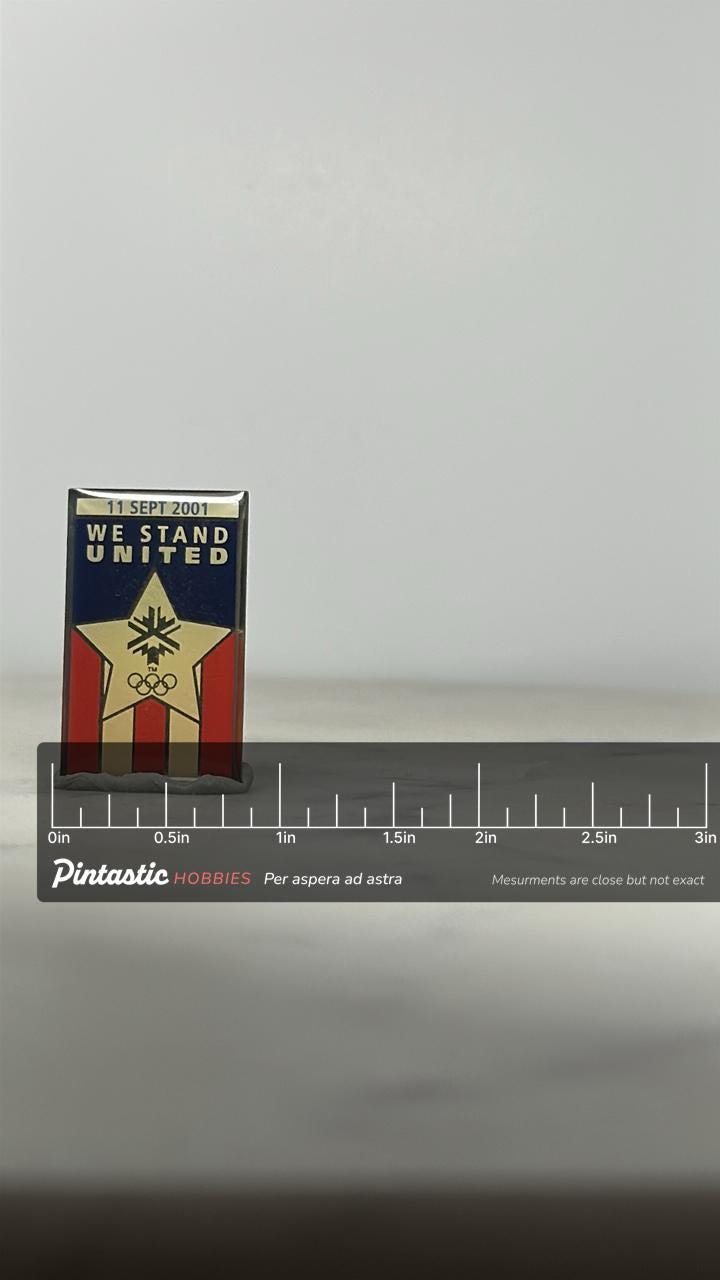 9/11 Olympic Tribute Pin: Gold & Red Enamel - Patriotic 2001 Accessory with ruler overlay for size reference