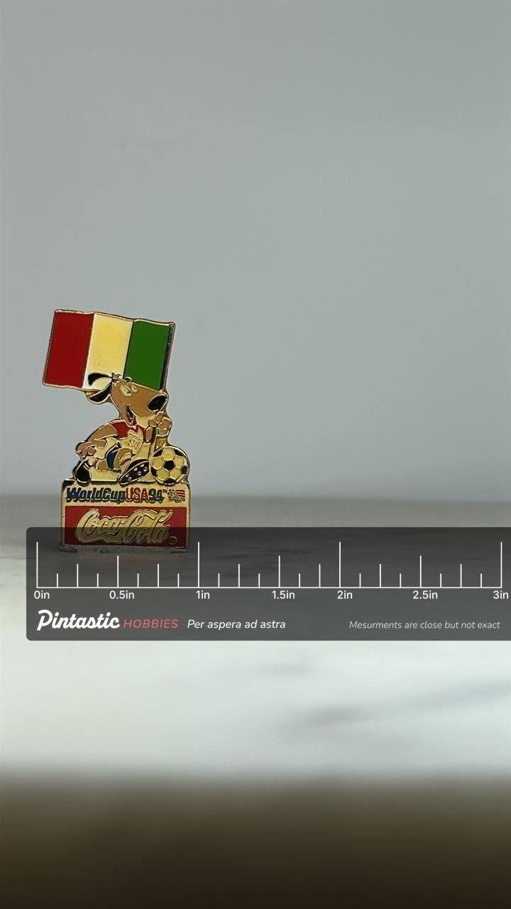 World Cup 1994 Coca-Cola Pin: Mascot & Italy Flag - Vintage Sports Accessory with ruler overlay for size reference