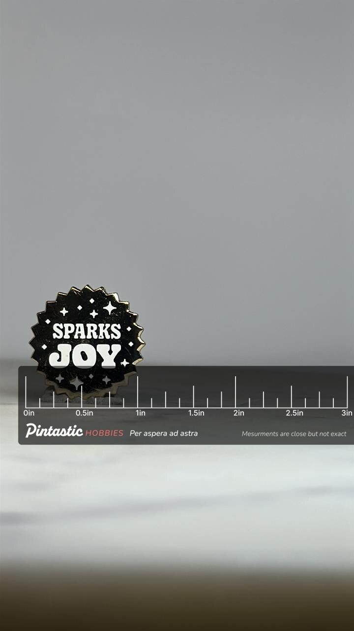 Sparks Joy Enamel Pin: Black & White Gold Starburst - Modern Positive Accessory with ruler overlay for size reference