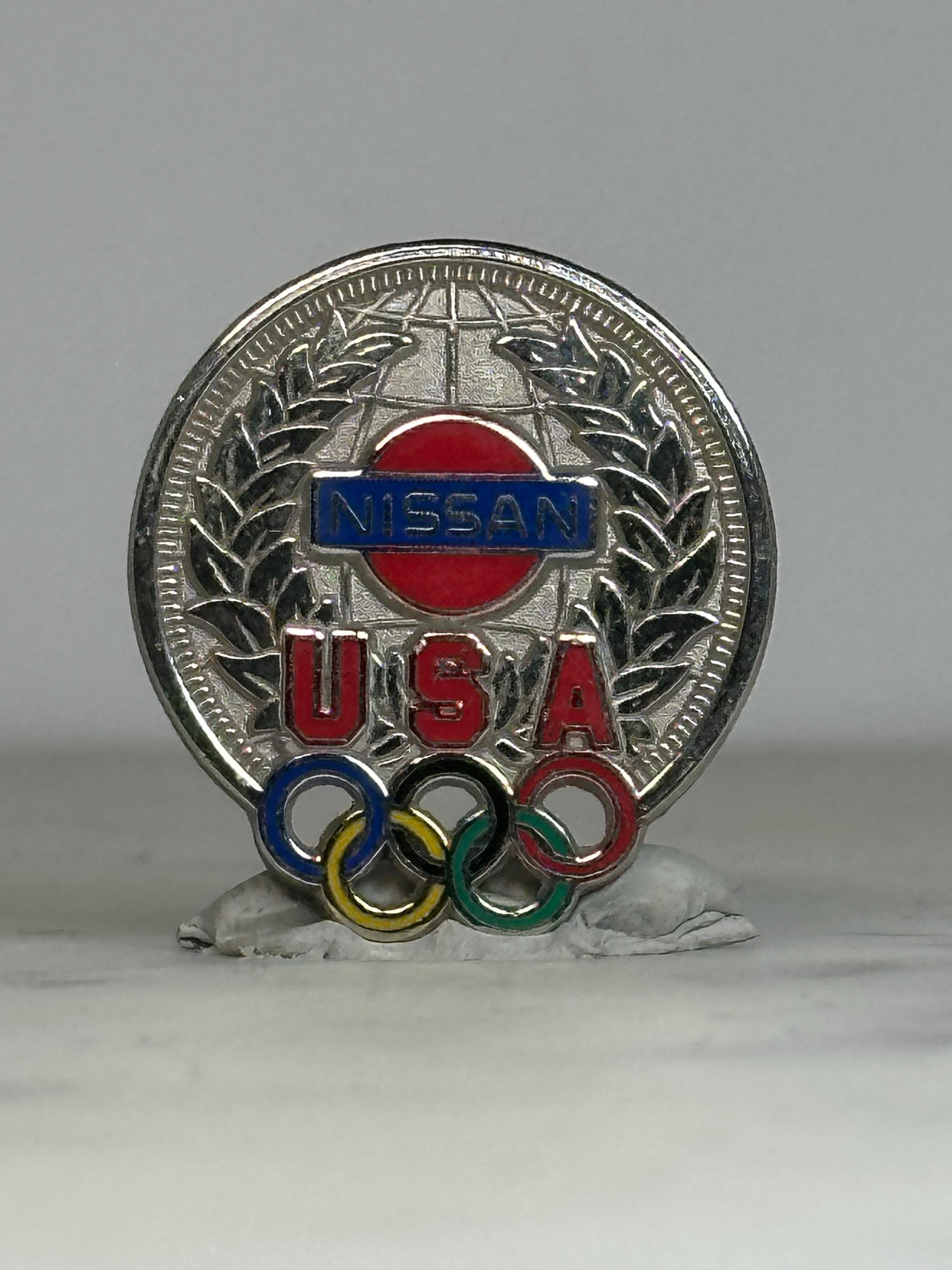 Nissan USA Olympic Pin: Silver Tone Enamel - Vintage Sports Accessory