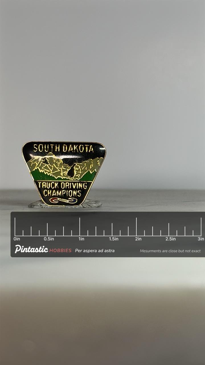 South Dakota Truck Driving Pin: Black & Green Enamel - Vintage Collectible Accessory with ruler overlay for size reference