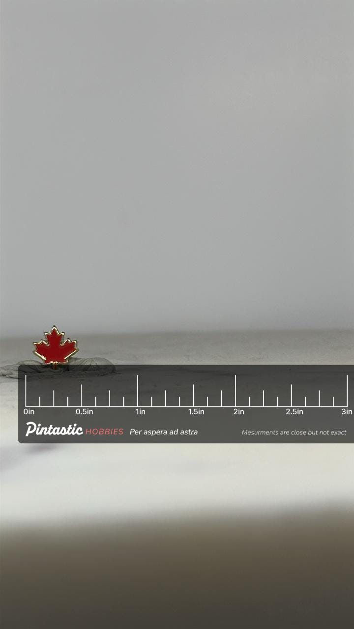 Canada Maple Leaf Pin: Red Enamel Gold Trim - Patriotic Accessory with ruler overlay for size reference