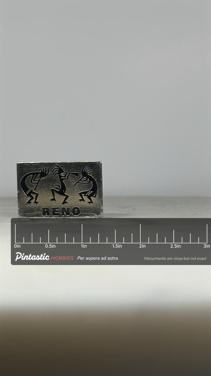 Reno Kokopelli Enamel Pin: Black on Silver Finish - Southwest Tourist Accessory with ruler overlay for size reference
