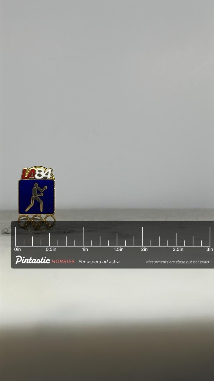 1984 LA Olympics Boxing Pin: Enamel Gold Tone - Retro Sports Accessory with ruler overlay for size reference