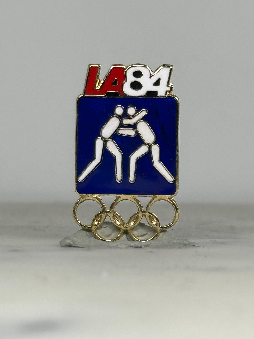 LA 84 Wrestling Olympic Pin: Blue Enamel & Gold Rings - Vintage Sports Accessory