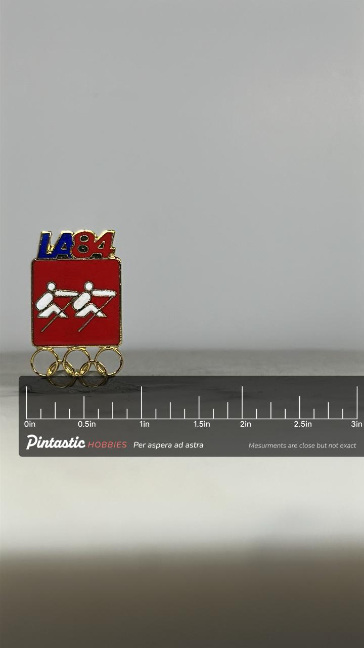 LA84 Olympics Rowing Pin: Red Enamel Gold Trim - 1984 Games Accessory with ruler overlay for size reference