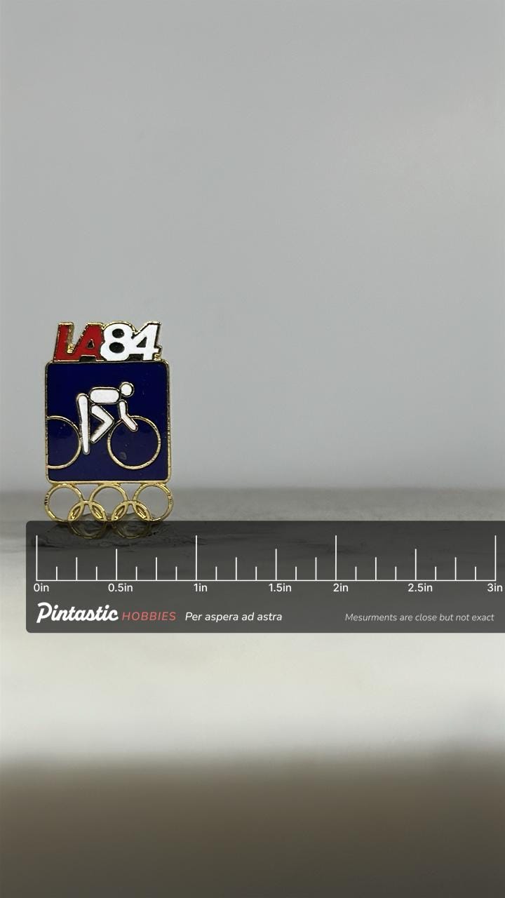 LA84 Olympic Cycling Pin: Red White Blue Enamel - Vintage Sports Accessory with ruler overlay for size reference