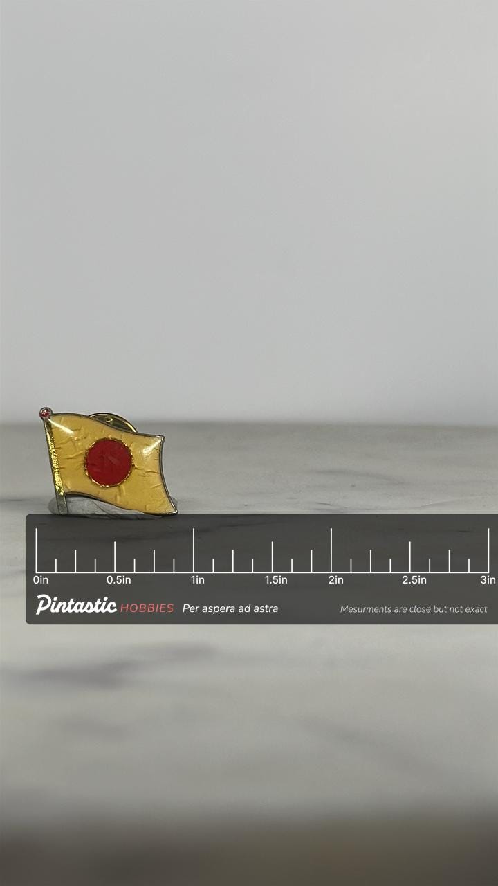 Japan Flag Enamel Pin: Yellow & Red Metal Finish - Vintage Travel Accessory with ruler overlay for size reference