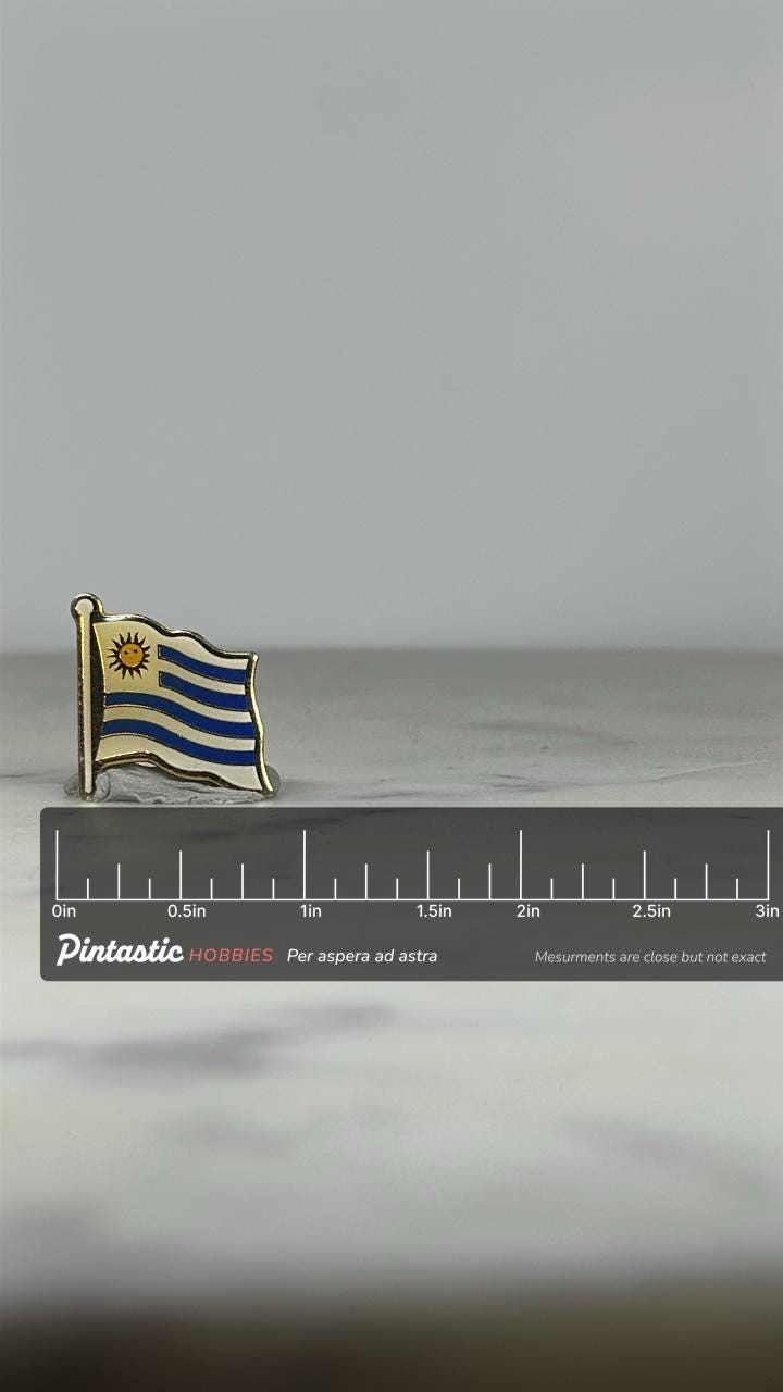 Uruguay Flag Enamel Pin: Gold & Blue Finish - Travel Souvenir Accessory with ruler overlay for size reference