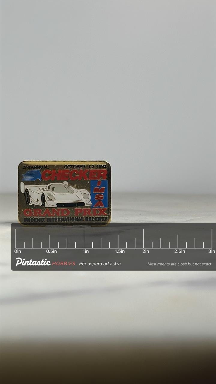 Checker Grand Prix Racing Pin: Gold & Multicolor - 1983 IMSA Accessory with ruler overlay for size reference