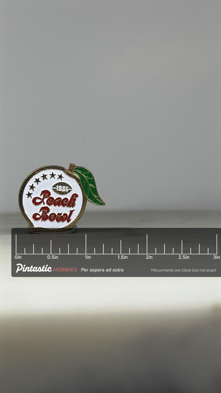 1985 Peach Bowl Pin: Enamel Finish - Vintage Sports Accessory with ruler overlay for size reference