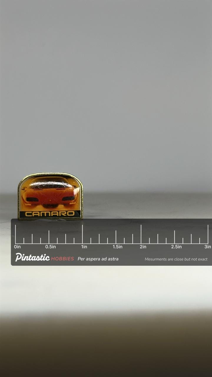 Camaro Car Collectible Pin: Glossy Finish Gold Trim - 1990s Muscle Car Accessory with ruler overlay for size reference