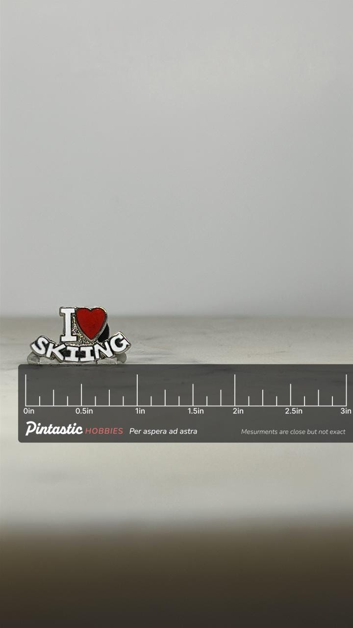 I Love Skiing Enamel Pin: Silver-Tone Red Heart - Retro Sports Accessory with ruler overlay for size reference