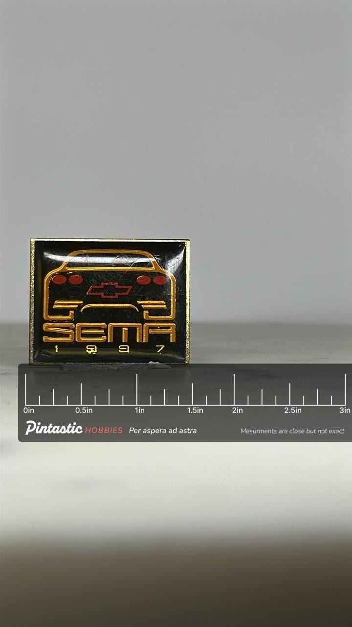 SEMA Chevy Car Pin: Black & Gold Enamel - 1997 Auto Show Accessory with ruler overlay for size reference