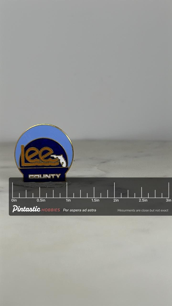 Lee County Lapel Pin: Blue Enamel Finish - Florida Souvenir Accessory with ruler overlay for size reference