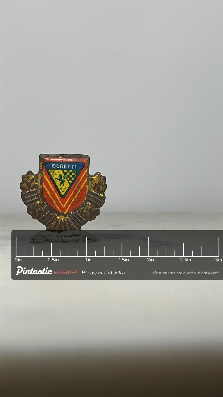 Doretti Car Emblem Pin: Red Gold Enamel Crest - Vintage Auto Accessory with ruler overlay for size reference