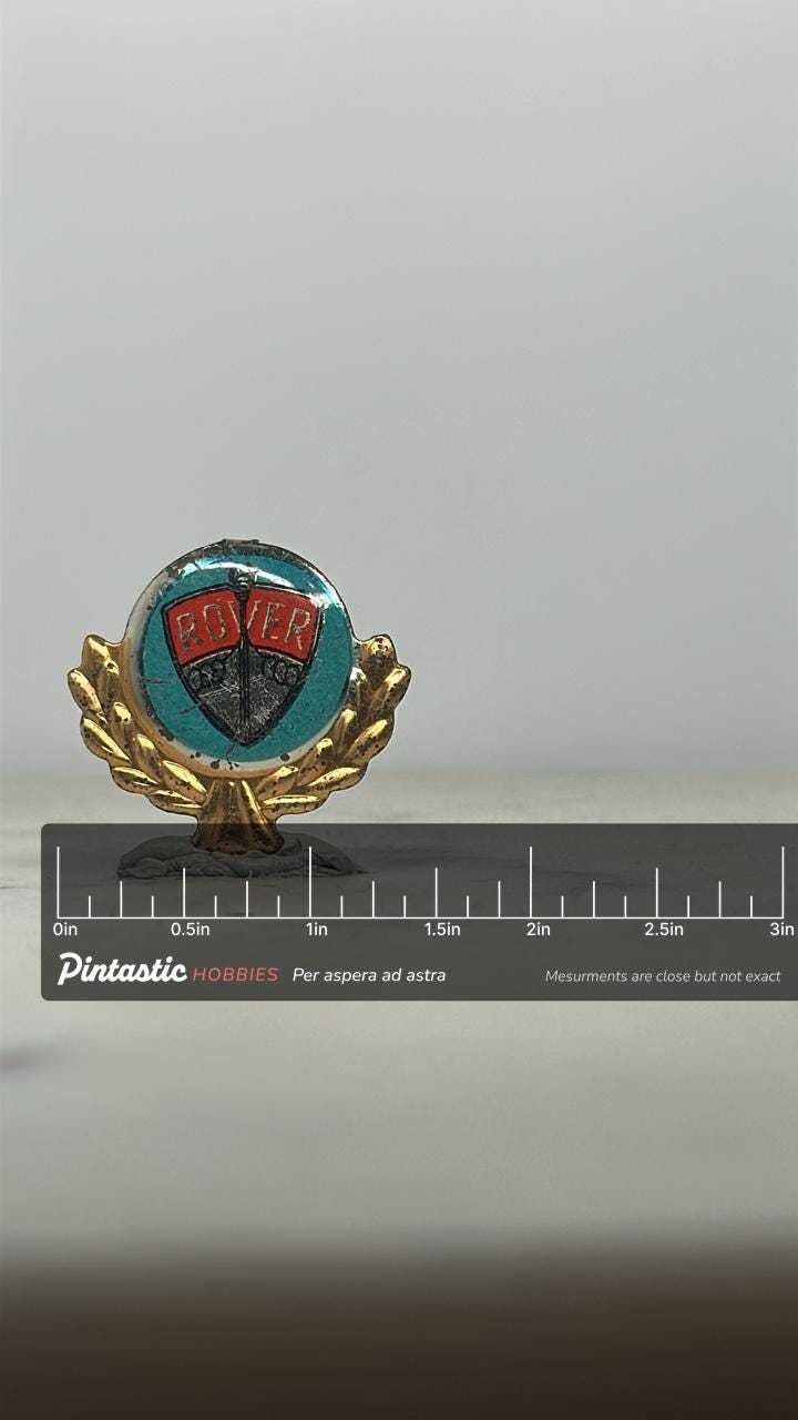 Rover Car Emblem Pin: Gold Laurel Wreath Finish - Vintage Auto Accessory with ruler overlay for size reference