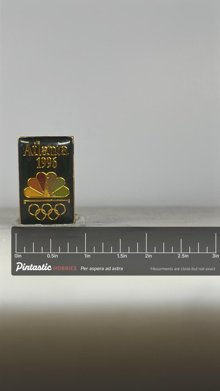 Atlanta 1996 Olympic Pin: Gold Tone NBC Logo - Vintage Sports Accessory with ruler overlay for size reference