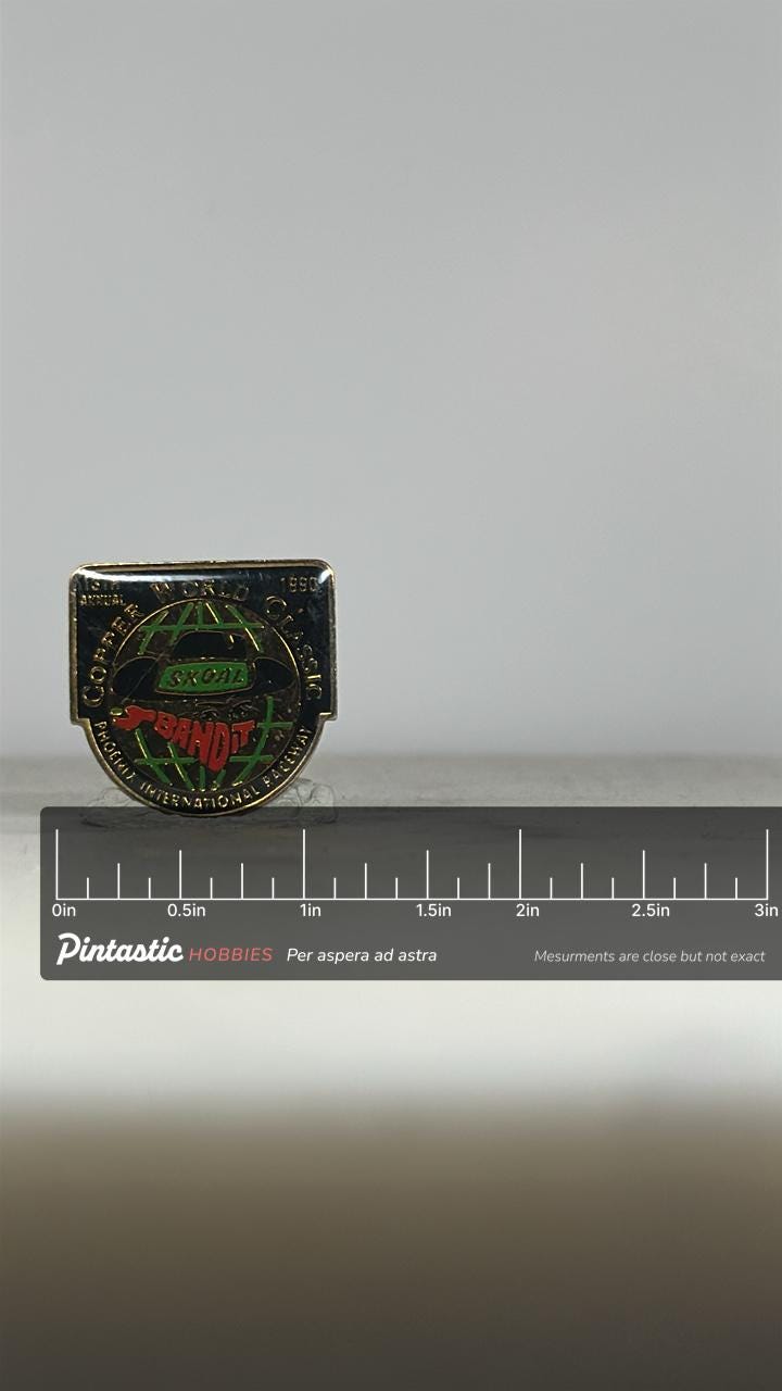Copper World Classic Racing Pin: Black/Gold Enamel - 1990 Motorsports Accessory with ruler overlay for size reference