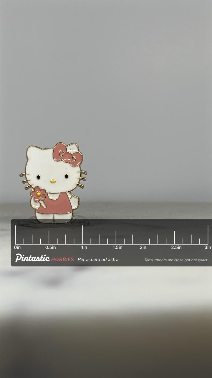 Hello Kitty Enamel Pin: Pink Outfit & Bow - Kawaii Retro Accessory with ruler overlay for size reference
