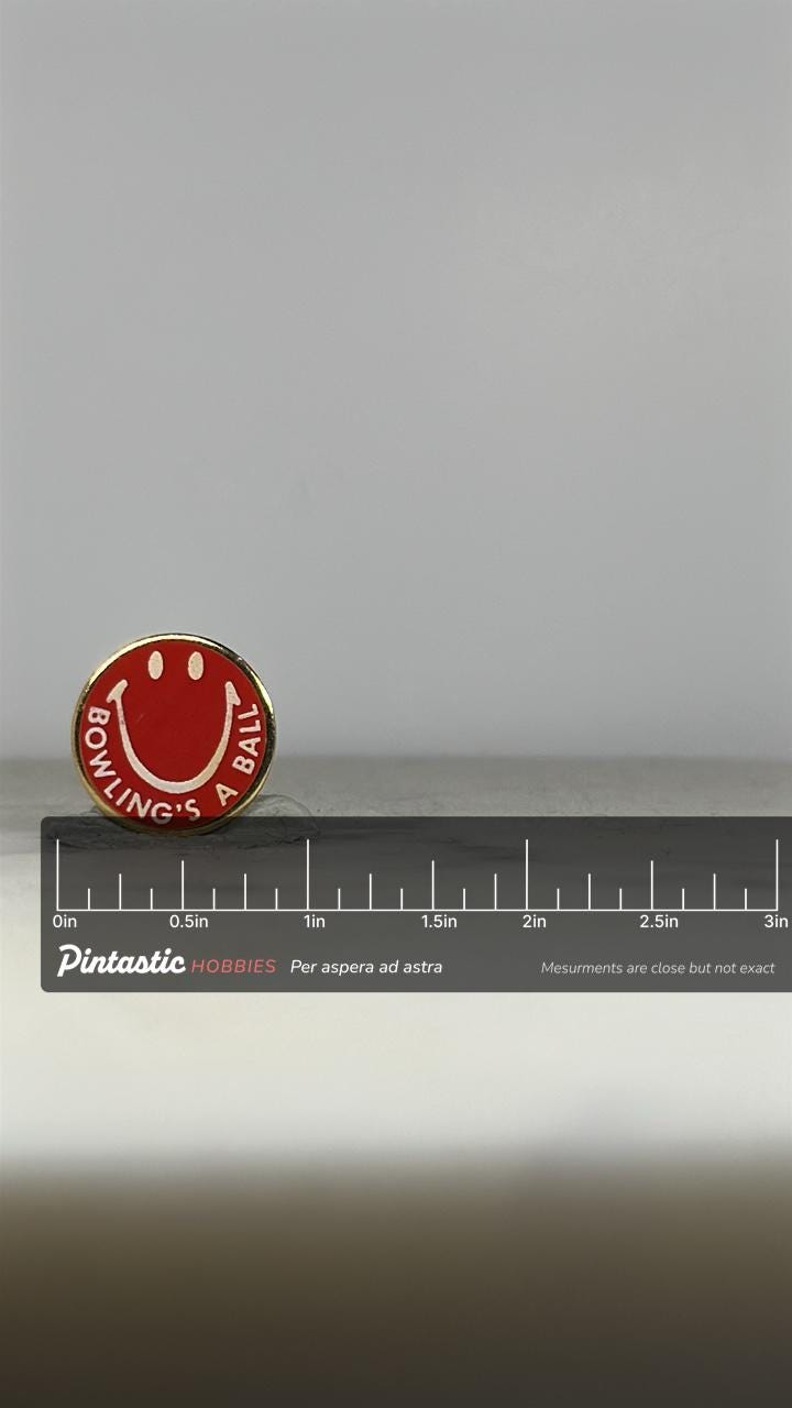 Bowling Smiley Enamel Pin: Red White Gold - Retro Sports Accessory with ruler overlay for size reference