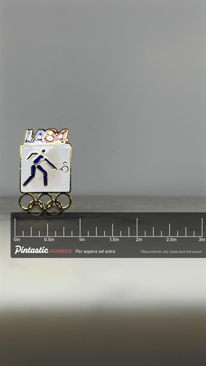 LA84 Olympic Tennis Pin: Blue Gold Enamel - 1984 Sports Accessory with ruler overlay for size reference