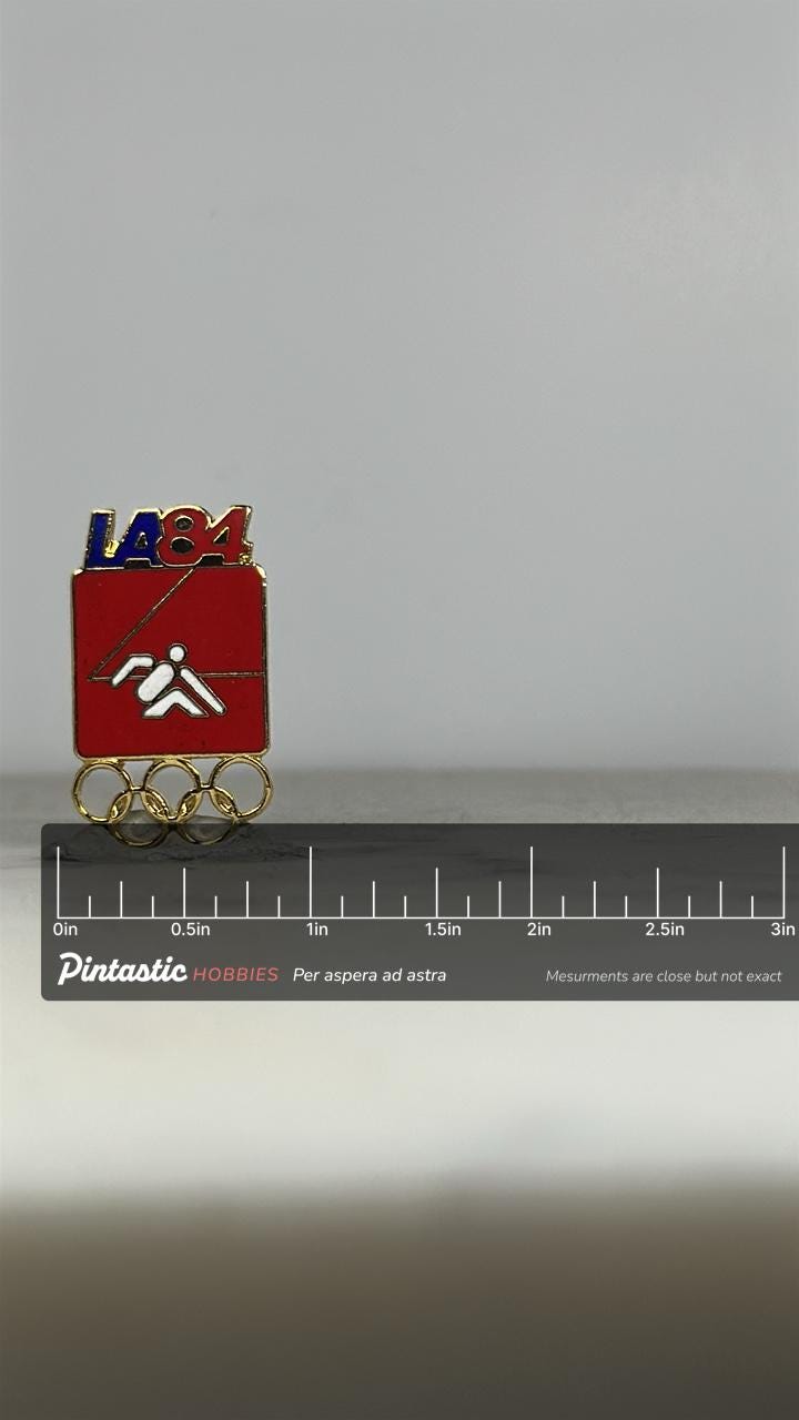 LA84 Olympic Yachting Pin: Red Enamel & Gold Finish - 1980s Sports Accessory with ruler overlay for size reference