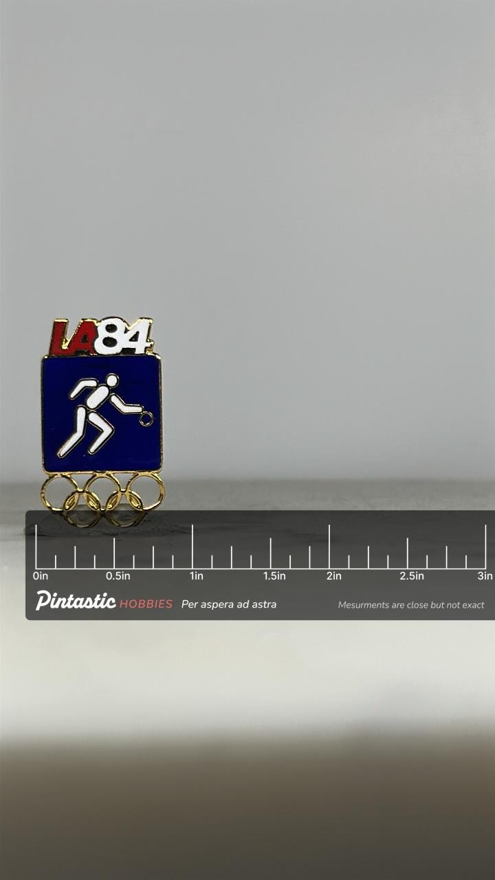 LA 1984 Basketball Olympic Pin: Blue Enamel - Vintage Sports Accessory with ruler overlay for size reference