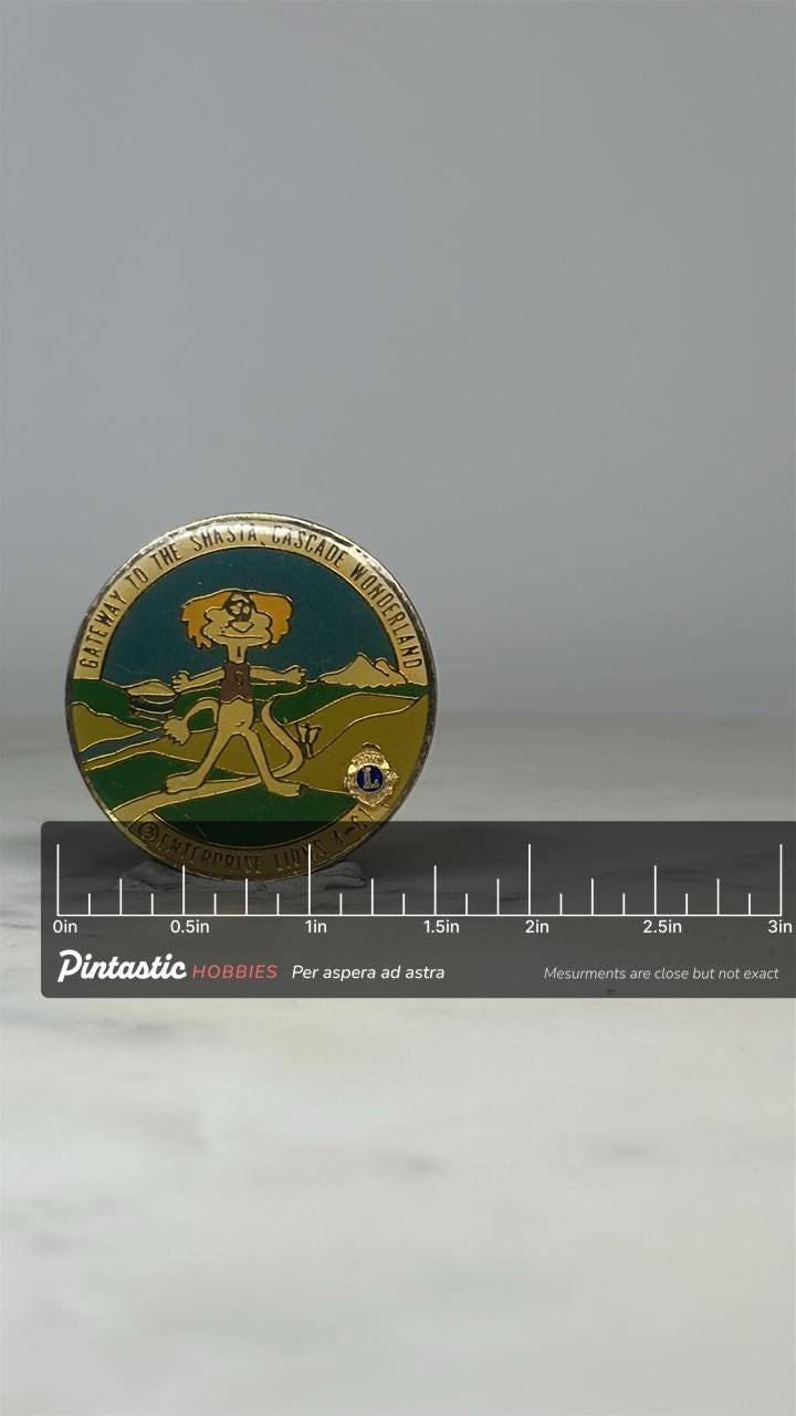 Shasta Cascade Enterprise Lions Pin: Enamel Goldtone - Lions Club Souvenir Accessory with ruler overlay for size reference