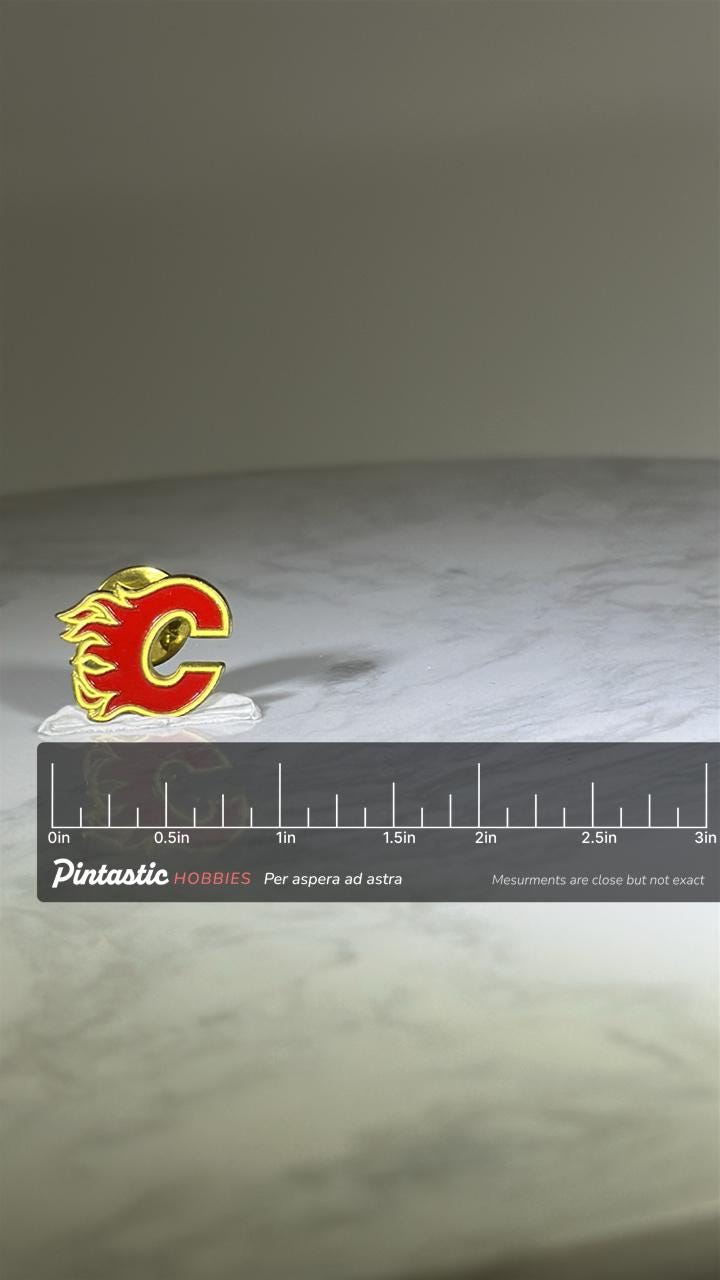 Calgary Flames Lapel Pin: Red Gold Enamel - NHL Hockey Accessory with ruler overlay for size reference