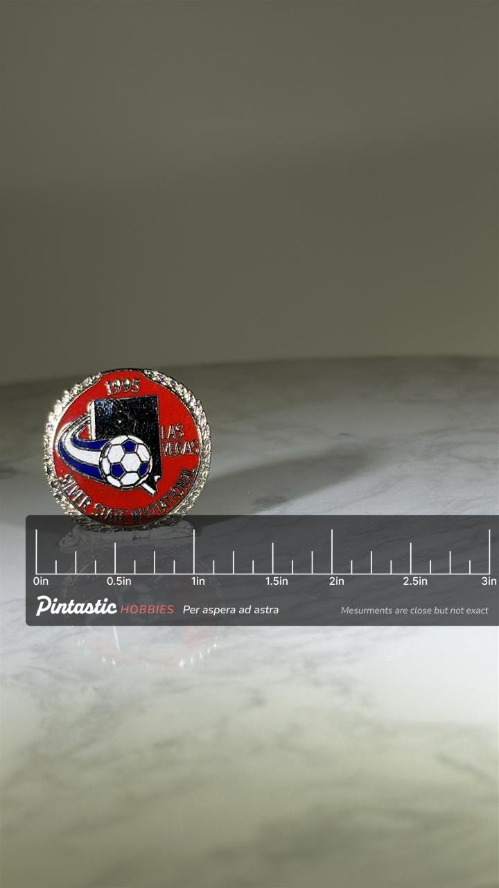 1995 Las Vegas Soccer Pin: Red Enamel Silver Trim - Sports Tournament Accessory with ruler overlay for size reference