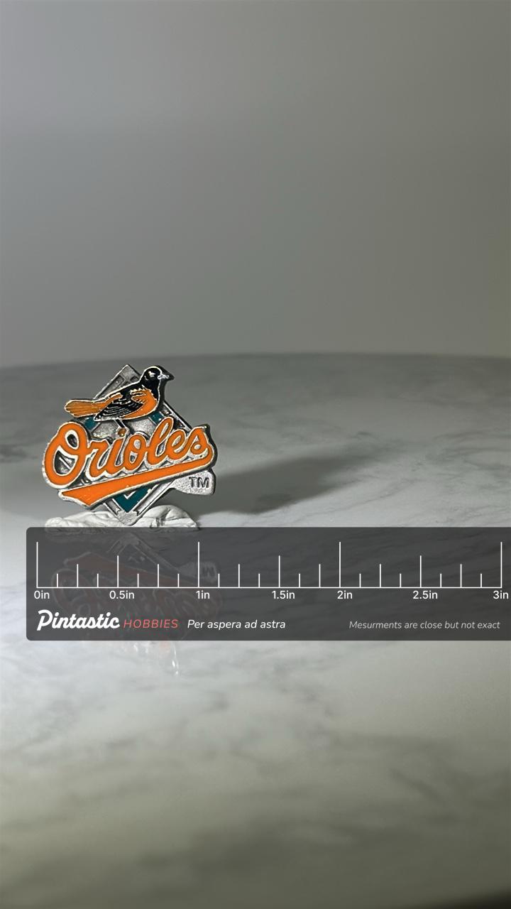 Baltimore Orioles Baseball Pin: Orange Enamel Metal - Vintage Sports Accessory with ruler overlay for size reference