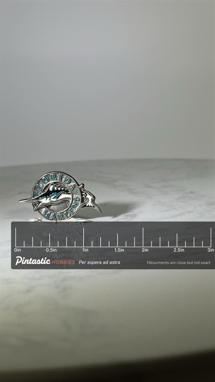 Florida Marlins Baseball Pin: Silver & Teal Enamel - 1990s Sports Accessory with ruler overlay for size reference